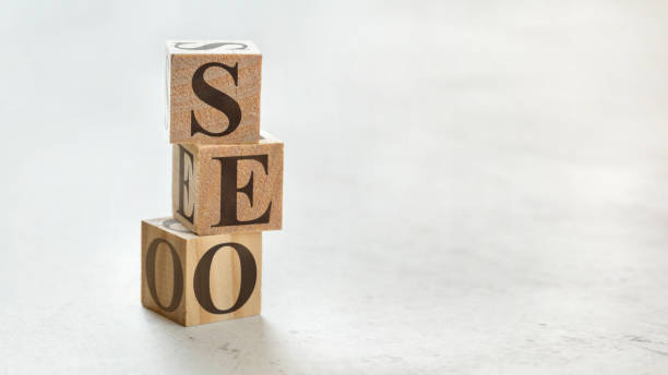istock Pile with three wooden cubes - letters SEO meaning Search Engine Optimization on them, space for more text / images at right side. 1130065320