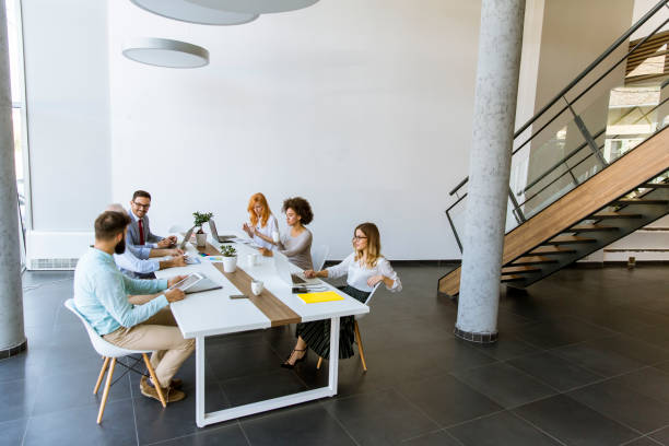 istock Joyful multiracial business team at work in modern office 1130067104