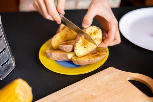 istock chef cook cut baked roasty potato b 1130068374