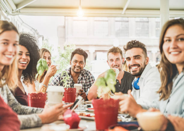 gruppo di amici felici che bevono caffè e cappuccino al bar vintage - giovani studenti che mangiano e parlano a colazione - amicizia, tendenza e concetto di cibo - focus sul viso dell'uomo indiano - muffin blueberry muffin blueberry food foto e immagini stock