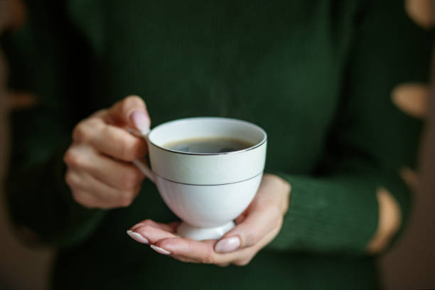 istock A cup of hot coffee in the hands. Concept drinks, lifestyle, work, background 1130070464