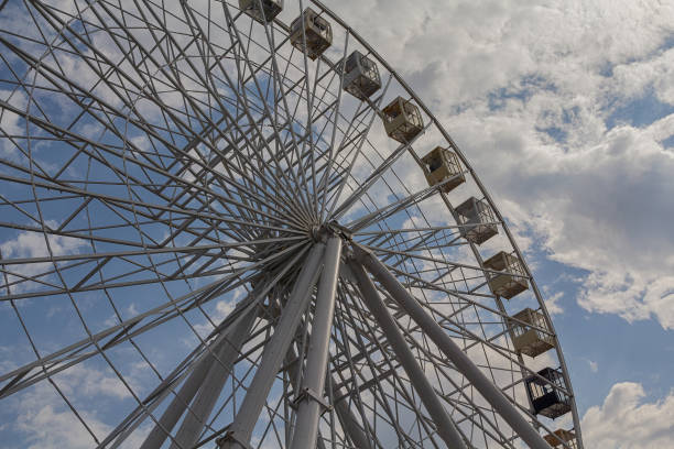 istock Ferris wheel on a background of blue sky and clouds 1130071641