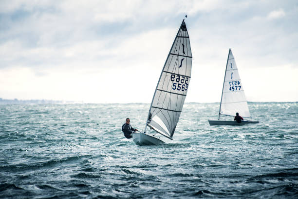 Dinghy Racing Hayling Island A number of Solo and Laser Dinghy Racing at a regular club meeting at Hayling Island sailing club on the southeast coast of England. sailing dinghy stock pictures, royalty-free photos & images