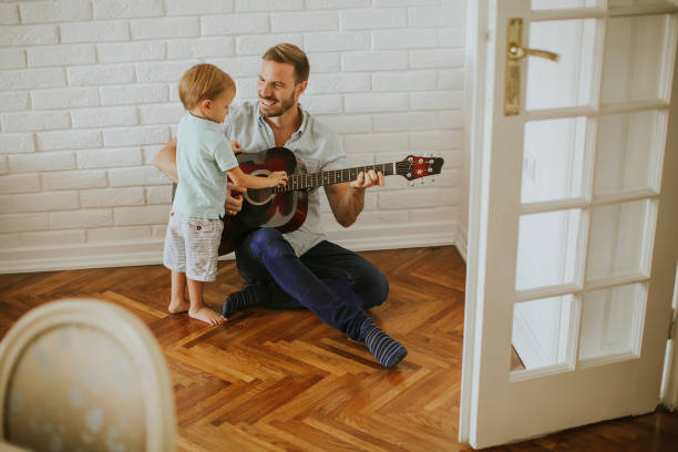 istock Father and little son with guitar 1130071853