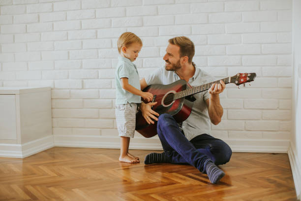 istock Father and little son with guitar 1130071856