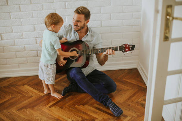 istock Father and little son with guitar 1130071862