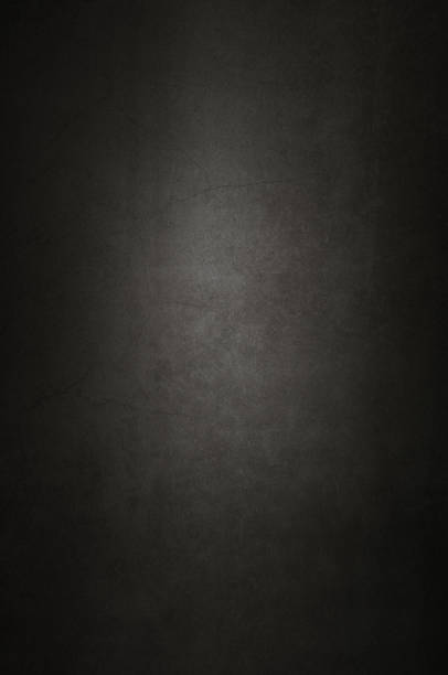 istock Background wall of aged textured old plaster black. 1130079863
