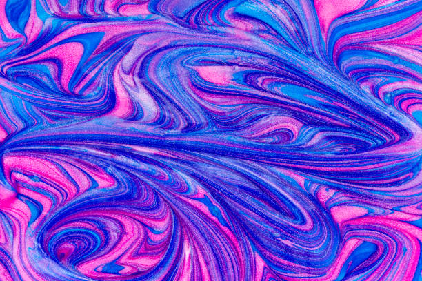 Close up detail in pink and blue metallic paint swirls