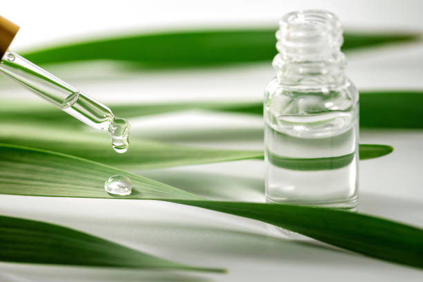 istock essential oil drop falling on green leaf from dropper 1130080333