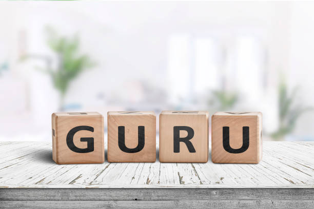 istock Guru sign on a wooden table in a bright room 1130082146