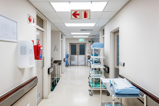 Packets on rack in empty corridor. Interior of hospital. Equipment in medical centre.