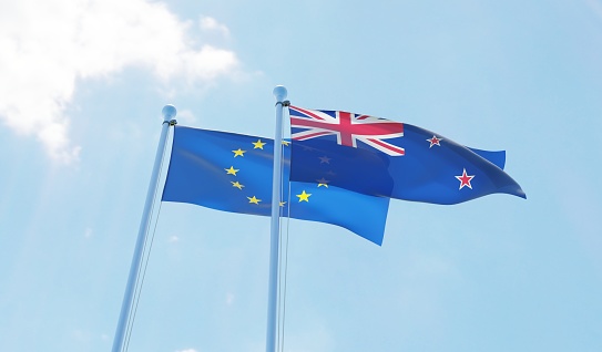 New Zealand and European Union, two flags waving against blue sky. 3d image