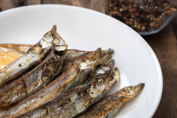 istock Grilled fish capelin or shishamo on white plate 1130089504