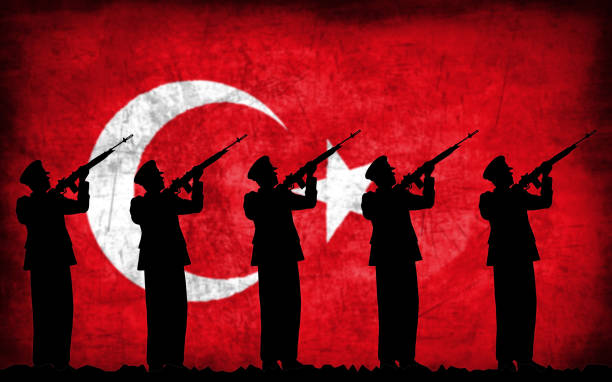 istock Soldiers with guns silhouette with Turkish flag 1130093530