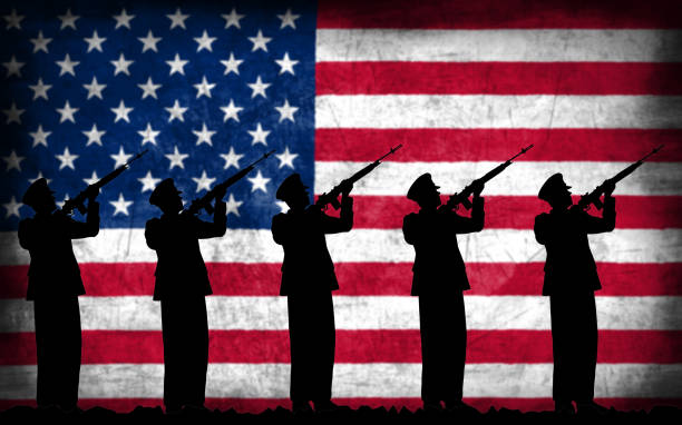 istock Soldiers with guns silhouette with American flag 1130093531