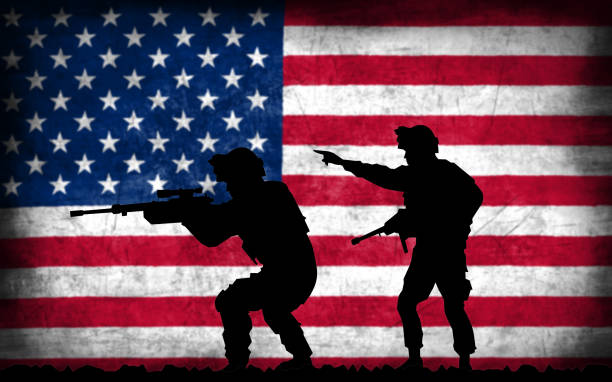 istock Soldiers with guns silhouette with American flag 1130093541