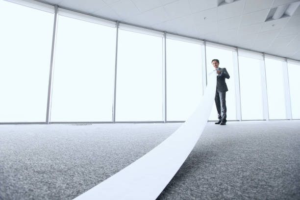 istock Businessman reading long paper list 1130093993