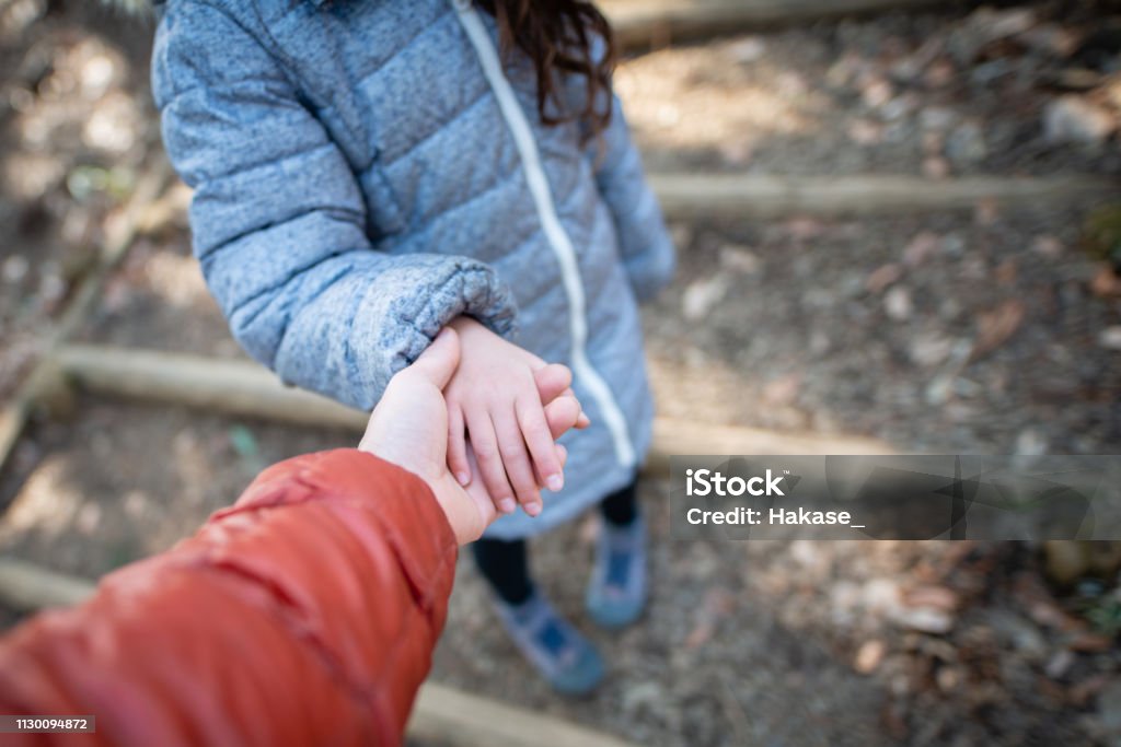 Father and daughter holding hands Child Stock Photo