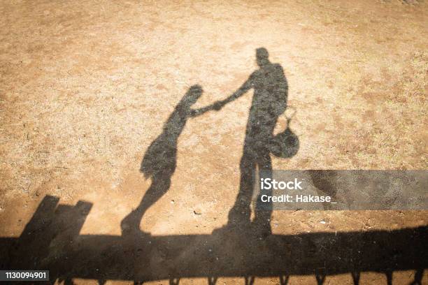 Shadow Of Father And Daughter Playing In The Park Stock Photo - Download Image Now - Adult, Beauty, Care