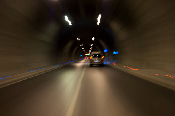 istock Long exposure tunnel with lights and speed limit signs. 1130095613