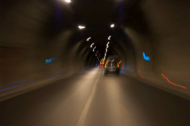 istock Long exposure tunnel with lights and speed limit signs. 1130095615