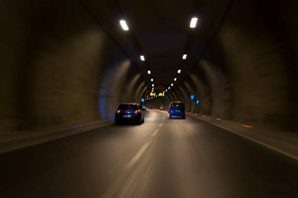 istock Long exposure tunnel with lights and speed limit signs. 1130095620