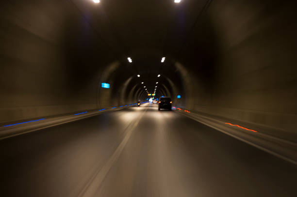 istock Long exposure tunnel with lights and speed limit signs. 1130095623