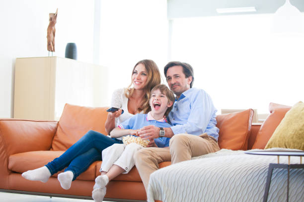 istock Family watching TV 1130096036