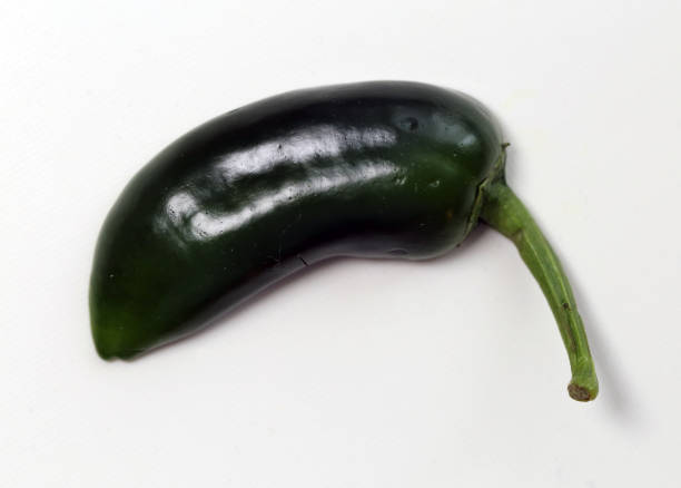 istock Halved Green Jalapeno pepper on a White Surface 1130098106