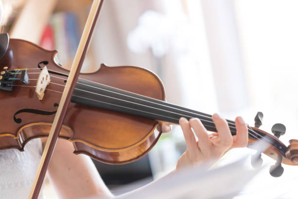 istock Young girl happily plays on her violin 1130099178