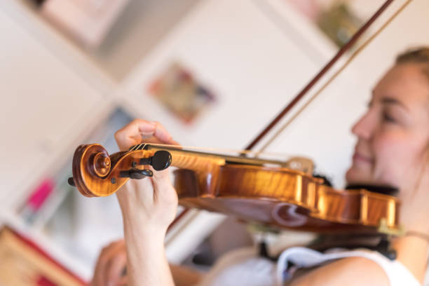 istock Young girl happily plays on her violin 1130099507