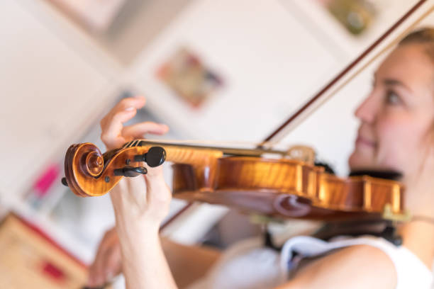 istock Young girl happily plays on her violin 1130099586