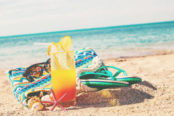 istock Beach background with a cocktail by the sea. Selective focus. 1130100550