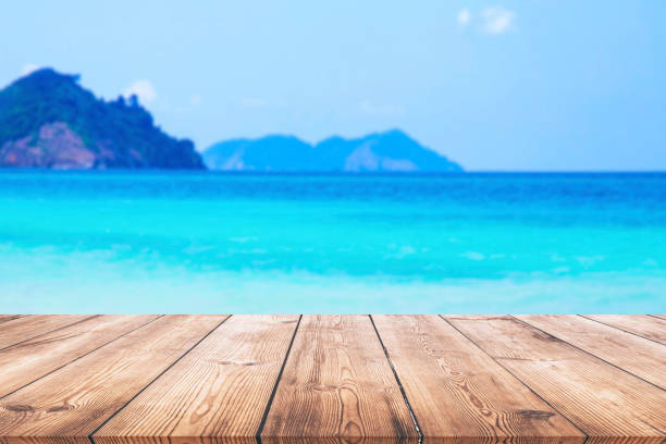 istock Wood table and beautiful sea with sand beach background 1130104587