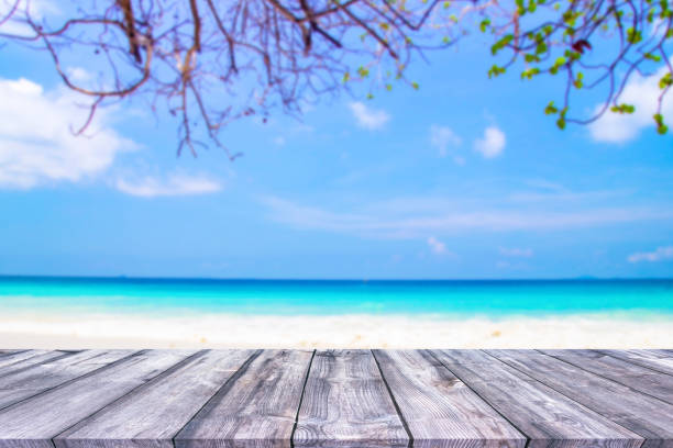 istock Wood table and beautiful sea with sand beach background 1130104592