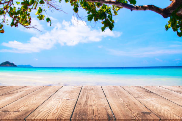 istock Wood table and beautiful sea with sand beach background 1130104669