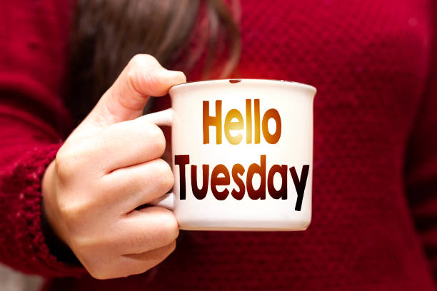 istock closeup woman drinking a coffee with hello Tuesday text 1130106337