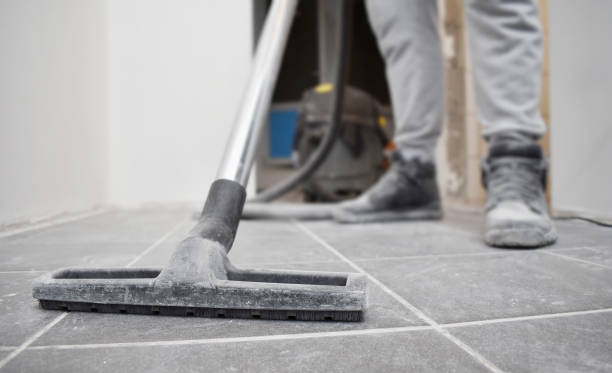 istock man vacuums the floor after repairs 1130107499