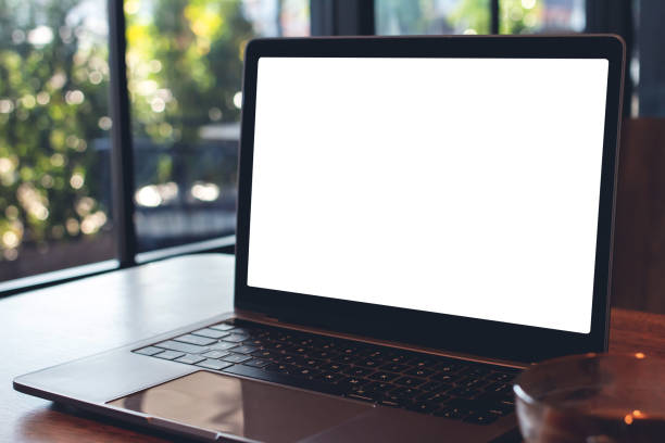 istock Mockup digital laptop blank white screen on wood table at  coffee shop 1130107916