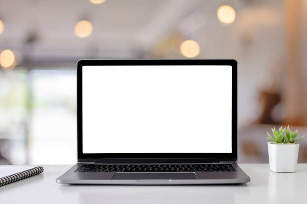 istock Mockup digital laptop blank white screen on wood table at  coffee shop 1130107935