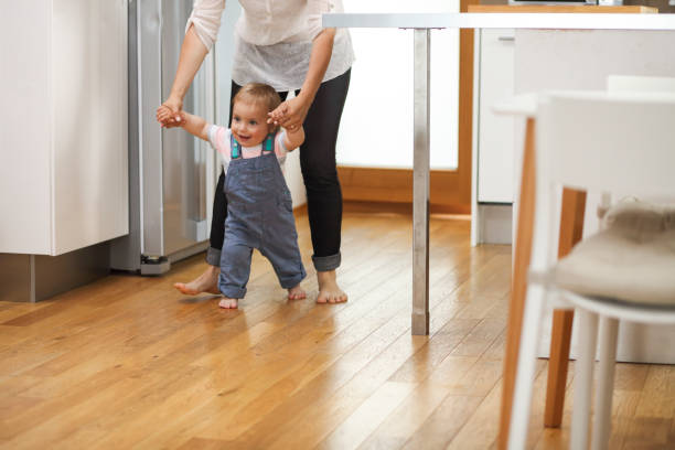 istock Mother teaching her boy to walk 1130108093