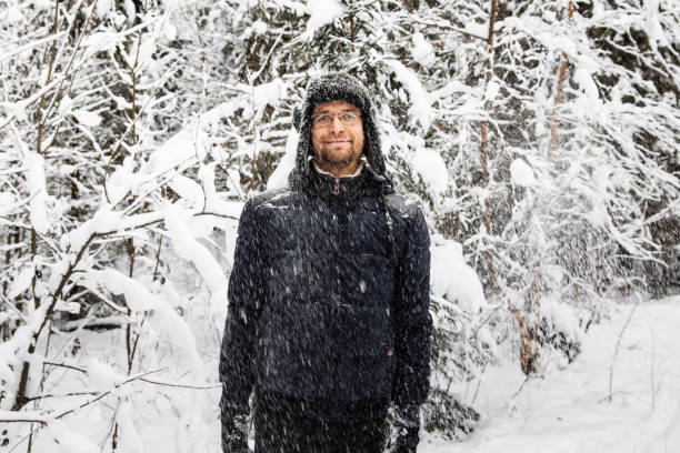 istock Man in fur winter hat with ear flaps smiling portrait 1130111021