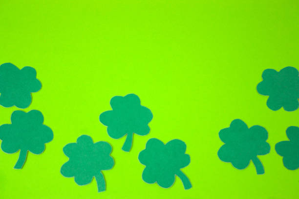 istock St Patricks Day  paper shamrocks over  green background 1130113354