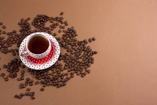 istock coffee cup and coffe beans mess on a brown background 1130113461