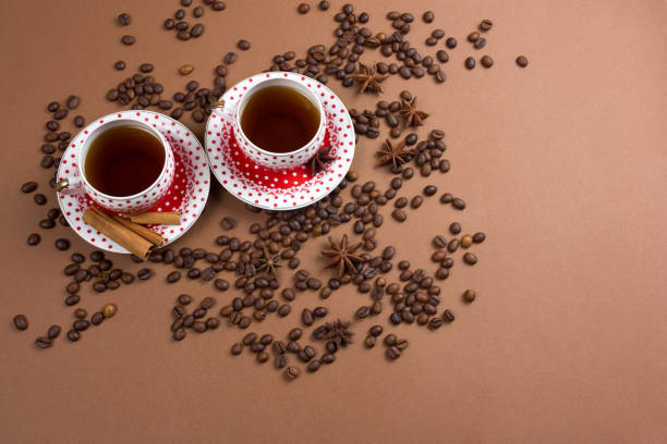 istock coffee cup and coffe beans mess on a brown background 1130113470