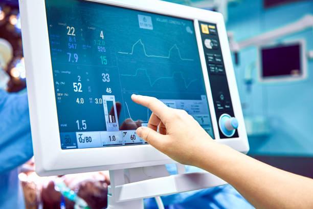 Monitoring patient's vital sign in operating room. doctor cheking at patient's vital signs. Cardiogram monitor during surgery in operation room. stock photo