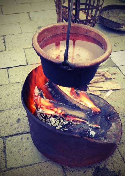 istock old copper cauldron over the fire made of burning woods 1130114449