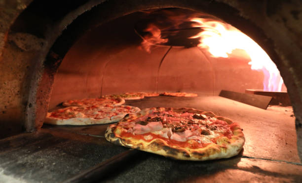istock oven and pizza removed from the pizza maker with a special shove 1130115016