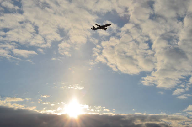 Airplane in the sky Airplane at sunset licht stock pictures, royalty-free photos & images
