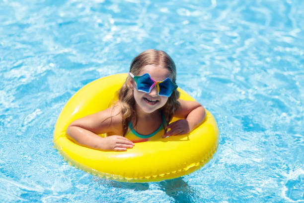 istock Child on float in swimming pool. Kids sunglasses. 1130115792